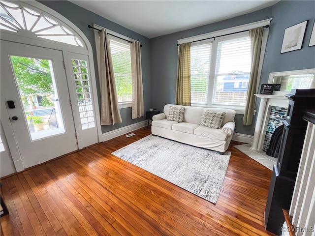 living room featuring light hardwood / wood-style floors and a wealth of natural light