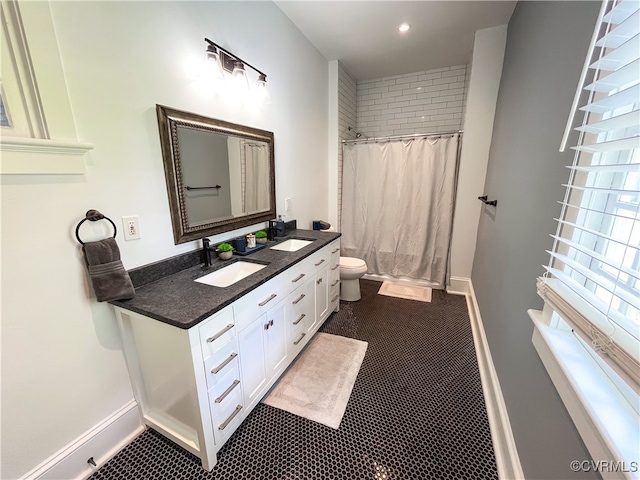 bathroom featuring vanity, a shower with shower curtain, and toilet