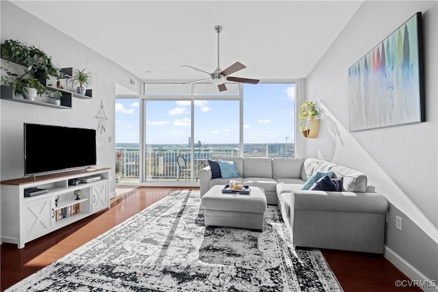 living room with visible vents, expansive windows, ceiling fan, wood finished floors, and baseboards