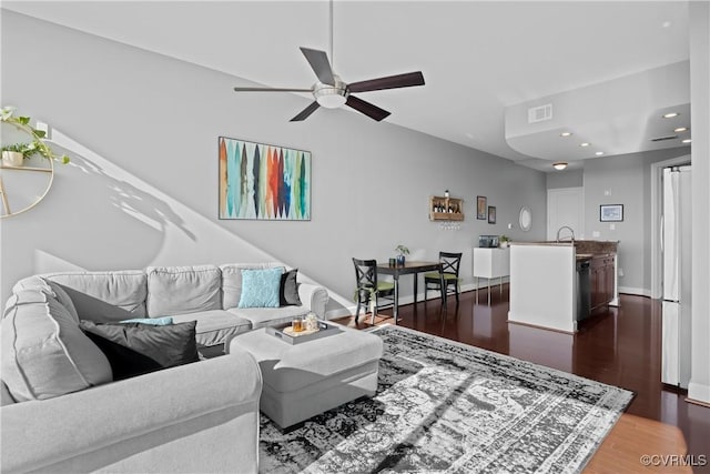 living area with dark wood finished floors, recessed lighting, visible vents, a ceiling fan, and baseboards