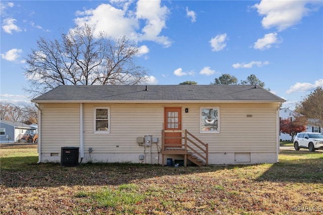 rear view of house featuring a yard and central AC