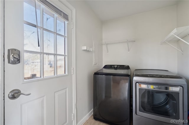 washroom with washing machine and clothes dryer