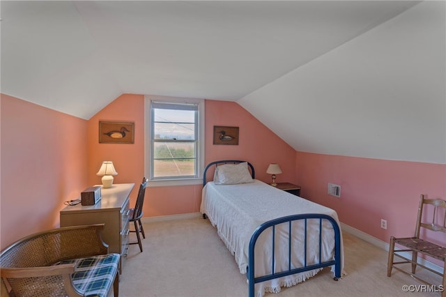 carpeted bedroom with vaulted ceiling