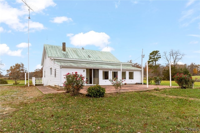 back of property featuring a lawn and a patio