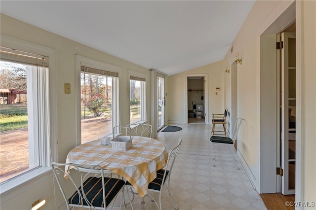 dining area with a wealth of natural light and lofted ceiling