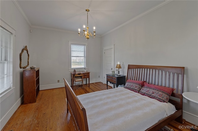 bedroom with hardwood / wood-style flooring, ornamental molding, and a notable chandelier