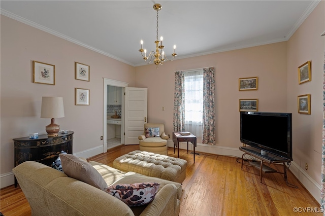 living room with wood-type flooring, an inviting chandelier, and crown molding