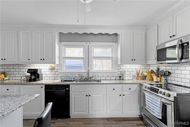 kitchen featuring white cabinets, stainless steel appliances, light stone countertops, and sink