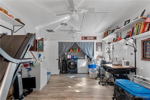 interior space featuring light wood-type flooring, separate washer and dryer, ceiling fan, and crown molding