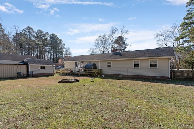 back of house with a lawn and a wooden deck