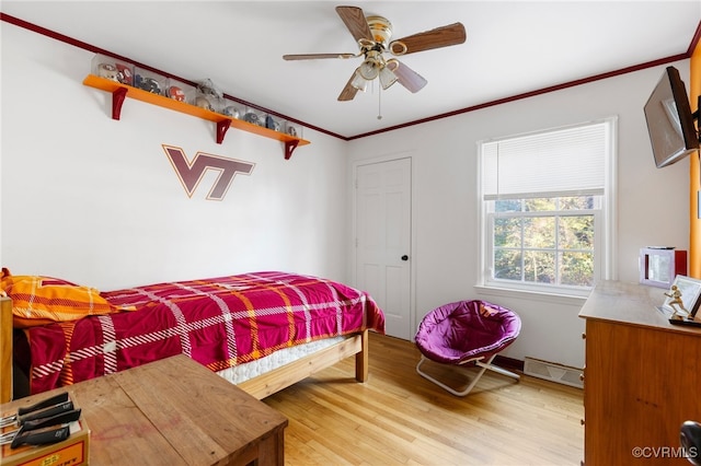 bedroom with ceiling fan, light hardwood / wood-style flooring, and crown molding