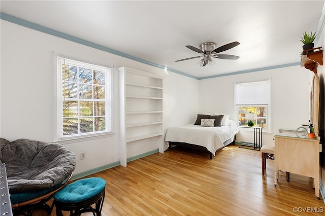 bedroom featuring light hardwood / wood-style flooring, ceiling fan, and crown molding