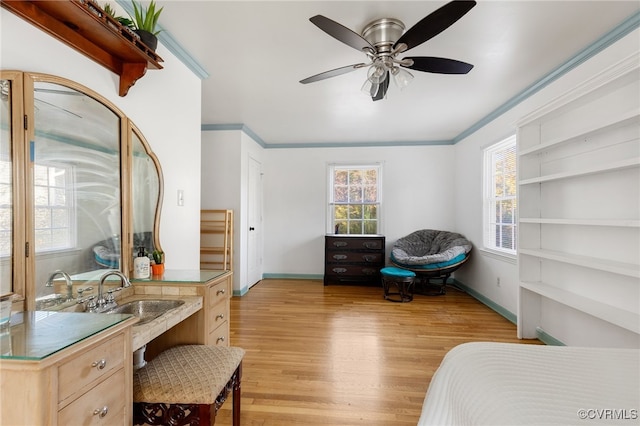 bedroom featuring ceiling fan, ornamental molding, and light hardwood / wood-style flooring