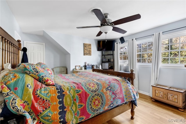 bedroom with light hardwood / wood-style floors and ceiling fan