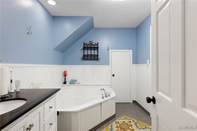 bathroom with tile patterned floors, vanity, and a washtub