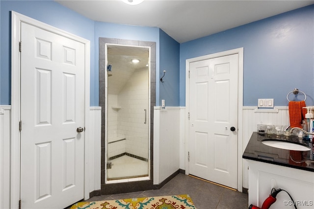 bathroom featuring tile patterned flooring, vanity, and an enclosed shower