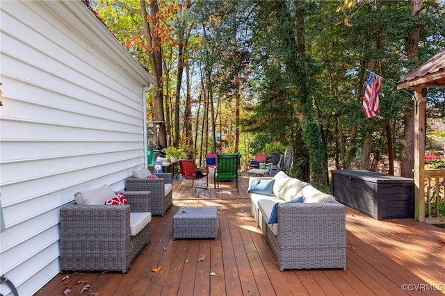 wooden terrace with an outdoor living space