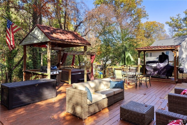 wooden deck with outdoor lounge area and a hot tub