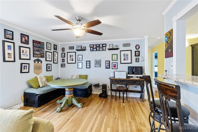 interior space featuring light hardwood / wood-style floors, ceiling fan, and crown molding