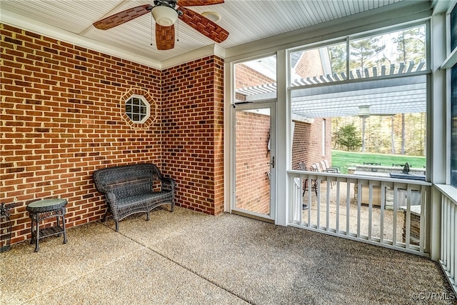 unfurnished sunroom with ceiling fan