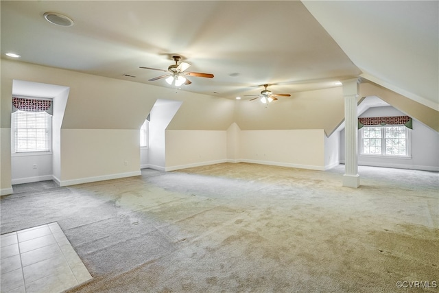 additional living space featuring ceiling fan, plenty of natural light, light carpet, and vaulted ceiling