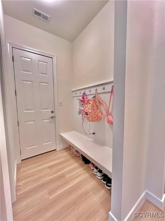 mudroom with light hardwood / wood-style floors