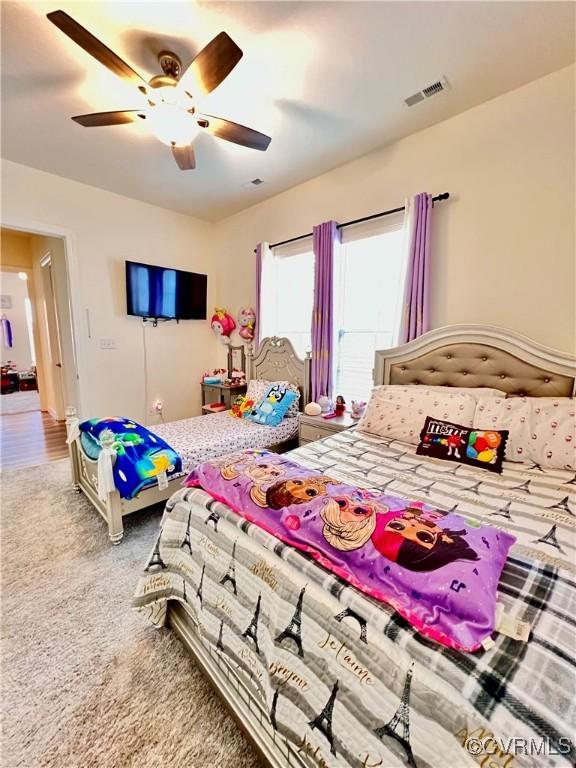 bedroom featuring ceiling fan and carpet