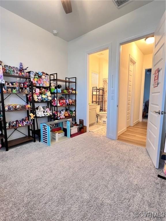 interior space featuring carpet floors and ceiling fan