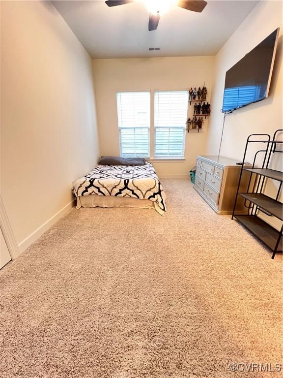 carpeted bedroom with ceiling fan