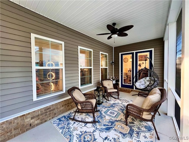 sunroom featuring ceiling fan