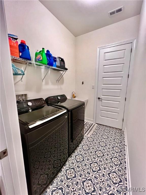 washroom with separate washer and dryer and sink