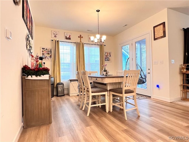 dining room featuring a chandelier and light hardwood / wood-style flooring