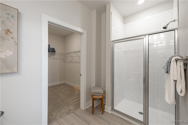 bathroom featuring hardwood / wood-style flooring and a shower with shower door