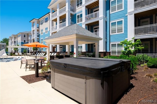 view of community featuring a patio area and a hot tub