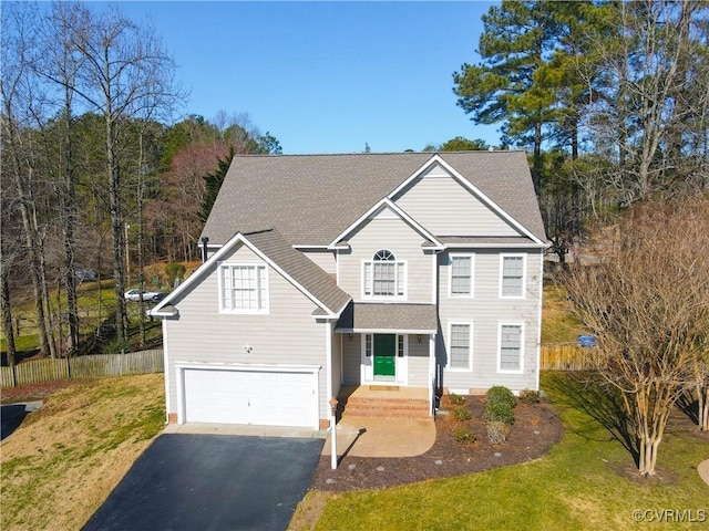 view of front of house featuring a front lawn and a garage