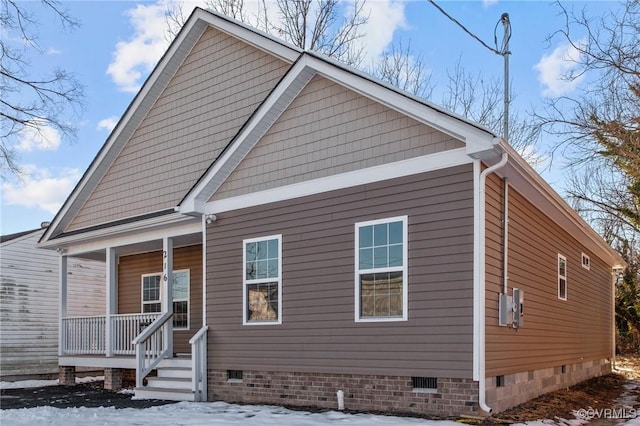 snow covered property featuring a porch