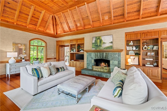 living room with a stone fireplace, hardwood / wood-style floors, high vaulted ceiling, and wood ceiling