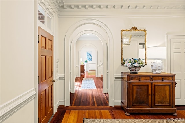 hall featuring wood-type flooring and ornamental molding