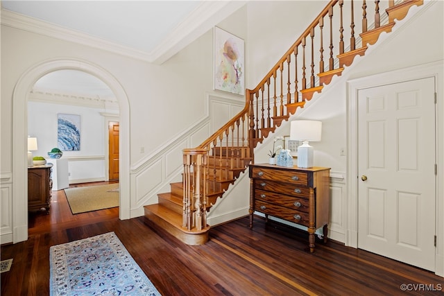 stairs featuring hardwood / wood-style flooring and crown molding