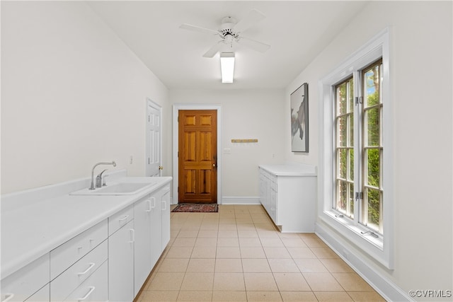 bathroom featuring tile patterned floors, ceiling fan, a healthy amount of sunlight, and sink