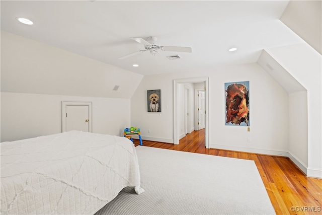 bedroom with hardwood / wood-style floors, ceiling fan, and vaulted ceiling