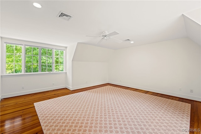 additional living space featuring hardwood / wood-style flooring, ceiling fan, and lofted ceiling