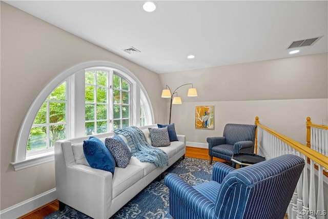 living room with plenty of natural light, dark hardwood / wood-style floors, and lofted ceiling