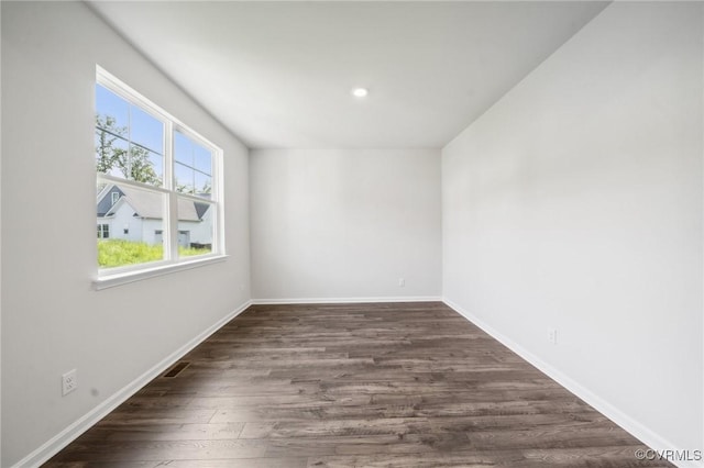 unfurnished room with dark hardwood / wood-style floors