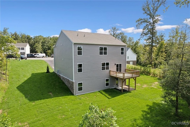 rear view of property with a wooden deck and a yard