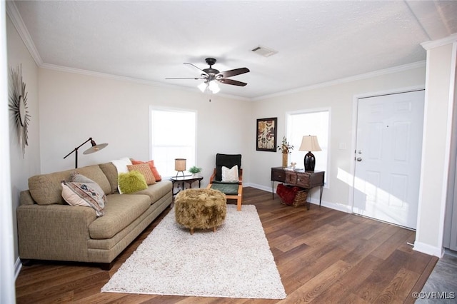 living room with dark hardwood / wood-style floors, ceiling fan, and crown molding