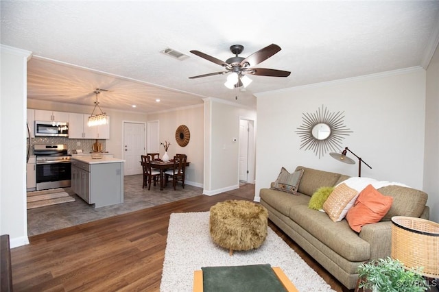 living room featuring ceiling fan, ornamental molding, and dark wood-type flooring