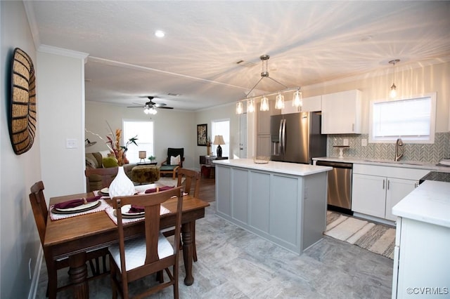 kitchen featuring white cabinets, pendant lighting, appliances with stainless steel finishes, and sink