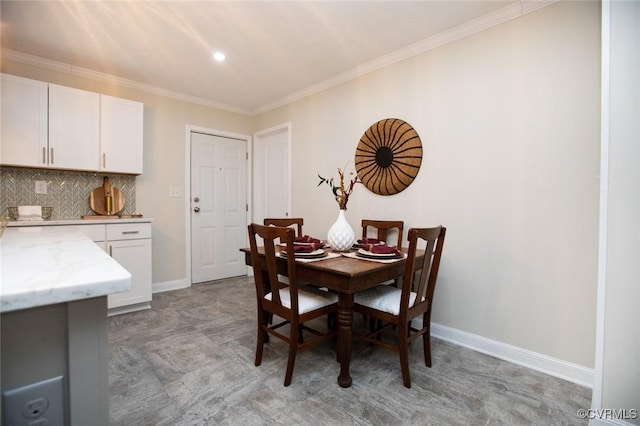 dining space with ornamental molding