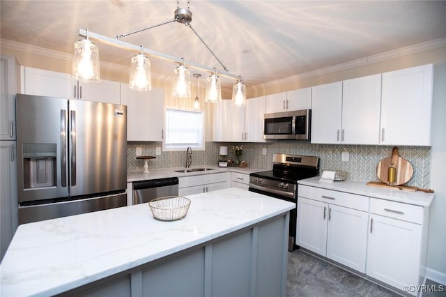 kitchen featuring light stone counters, stainless steel appliances, white cabinetry, and sink